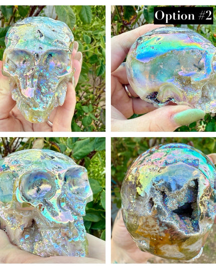 A mesmerizing Genuine Quartz Skull Carving with Rainbow Aura Treatment glows with an ethereal spectrum of colors, resting against a dark, reflective surface. The quartz base is expertly carved into a detailed skull, complete with defined features and a polished finish. The surface shimmers with iridescent hues—vivid blues, purples, pinks, and golds—created through the rainbow aura treatment, a process that bonds precious metals to the quartz for a permanent, luminous effect.
