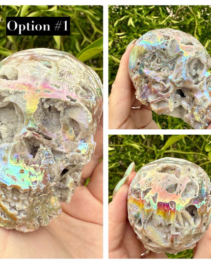 A mesmerizing Genuine Quartz Skull Carving with Rainbow Aura Treatment glows with an ethereal spectrum of colors, resting against a dark, reflective surface. The quartz base is expertly carved into a detailed skull, complete with defined features and a polished finish. The surface shimmers with iridescent hues—vivid blues, purples, pinks, and golds—created through the rainbow aura treatment, a process that bonds precious metals to the quartz for a permanent, luminous effect.
