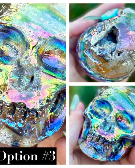 A mesmerizing Genuine Quartz Skull Carving with Rainbow Aura Treatment glows with an ethereal spectrum of colors, resting against a dark, reflective surface. The quartz base is expertly carved into a detailed skull, complete with defined features and a polished finish. The surface shimmers with iridescent hues—vivid blues, purples, pinks, and golds—created through the rainbow aura treatment, a process that bonds precious metals to the quartz for a permanent, luminous effect.