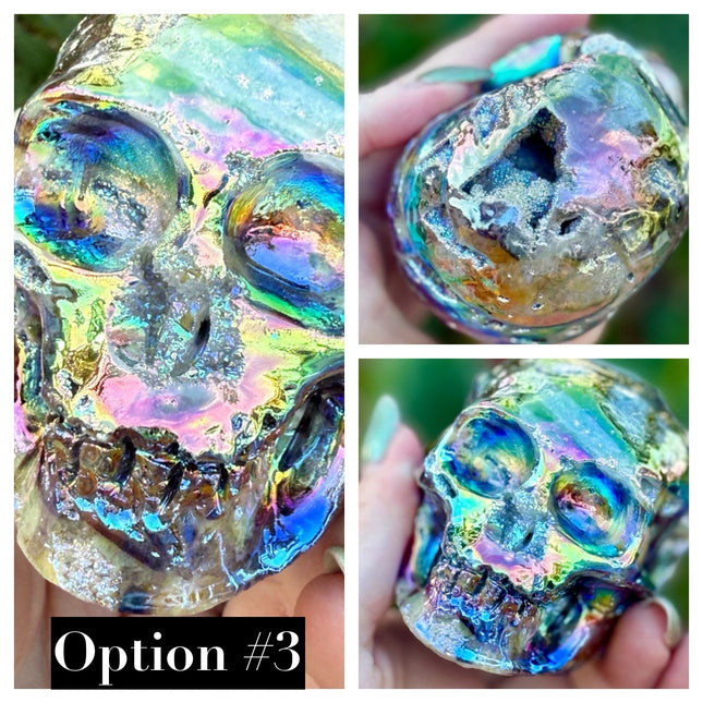 A mesmerizing Genuine Quartz Skull Carving with Rainbow Aura Treatment glows with an ethereal spectrum of colors, resting against a dark, reflective surface. The quartz base is expertly carved into a detailed skull, complete with defined features and a polished finish. The surface shimmers with iridescent hues—vivid blues, purples, pinks, and golds—created through the rainbow aura treatment, a process that bonds precious metals to the quartz for a permanent, luminous effect.