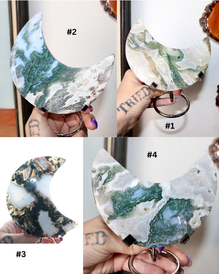 Collection of green and white moss agate stone crescent moon-shaped decorations with numbers indicating variations.