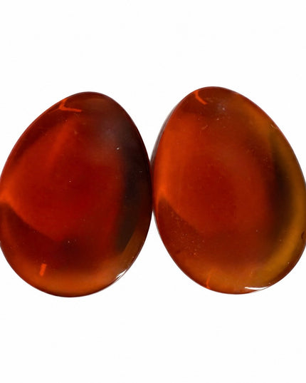Two smooth, polished gauges in a warm reddish-brown amber color, displayed side-by-side on a solid white background.