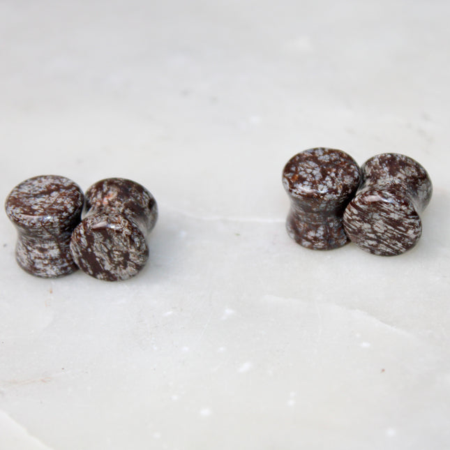 These Double Flare Brown Snowflake Obsidian Plugs bring together natural stone beauty and meaningful energy—perfect for everyday wear, spiritual practice, or anyone seeking balance with a striking, earthy edge.