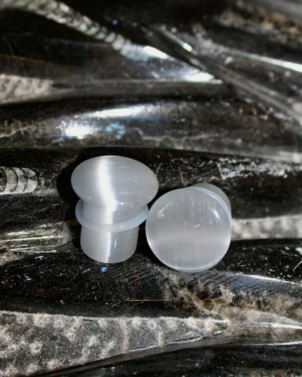 Silver Cat’s Eye glass is known for its sophisticated shimmer and luminous, moving line—known as chatoyancy—that dances across the surface like a beam of light. The cool, metallic tone represents clarity, balance, and subtle strength, making it a versatile choice for everyday wear or a sleek accent piece.