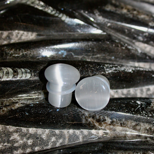 Silver Cat’s Eye glass is known for its sophisticated shimmer and luminous, moving line—known as chatoyancy—that dances across the surface like a beam of light. The cool, metallic tone represents clarity, balance, and subtle strength, making it a versatile choice for everyday wear or a sleek accent piece.