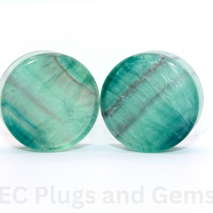Rainbow Fluorite Double Flare Plugs and gemstones on a white background with 'EC Plugs and Gems' text.