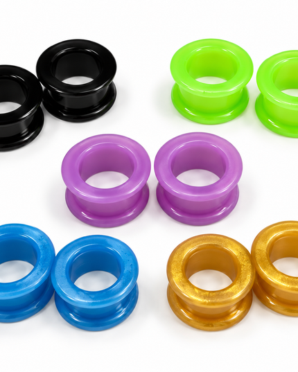 Six pairs of glossy circular plug rings in black, neon green, purple, blue, and metallic gold, arranged on a clean white background.