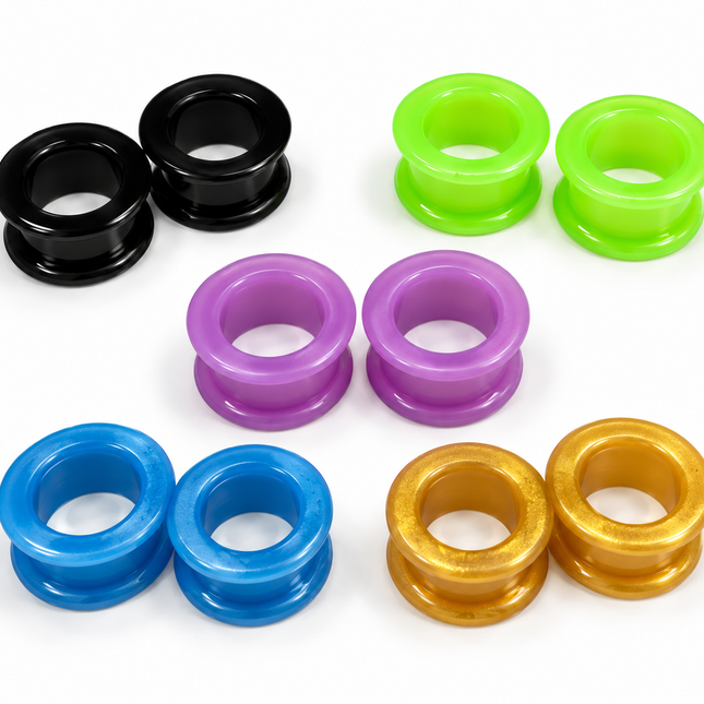Six pairs of glossy circular plug rings in black, neon green, purple, blue, and metallic gold, arranged on a clean white background.