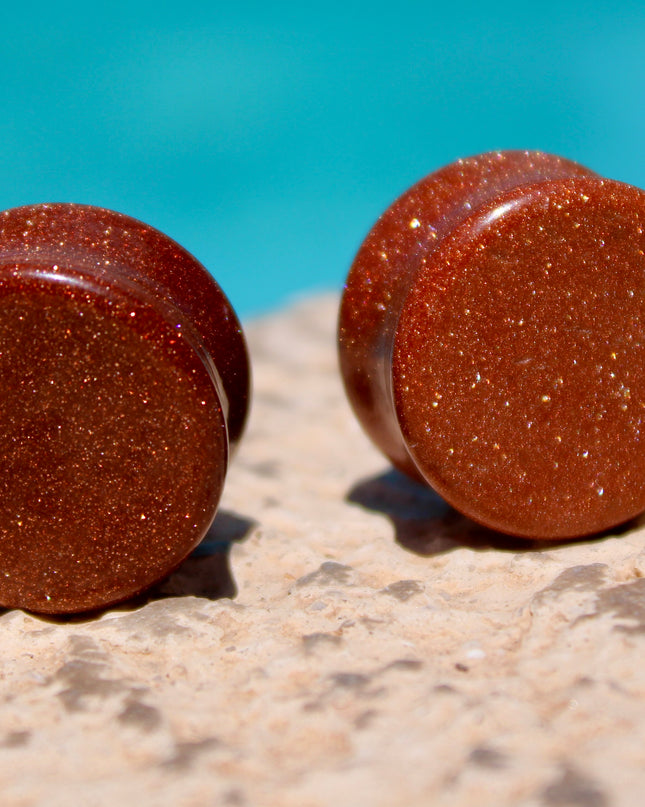 Goldstone double flared plugs organic glitter