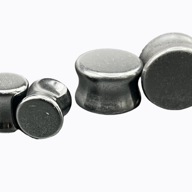 Crafted from polished natural hematite, these plugs offer a sleek, metallic finish with a cool, gunmetal-gray sheen. Smooth and weighty, hematite plugs provide a comfortable fit while giving off a bold, minimalist look. Known for its grounding and balancing properties, hematite is a favorite among those who seek both style and energetic stability. Ideal for stretched ears, these plugs combine natural beauty with a modern edge.