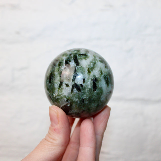Green Tourmaline in Quartz Sphere - 57mm Stone Sphere with Plastic Display Stand Included - Green, White, and Black Stone Ball
