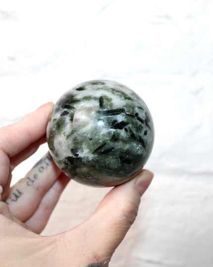 Green Tourmaline in Quartz Sphere - 57mm Stone Sphere with Plastic Display Stand Included - Green, White, and Black Stone Ball