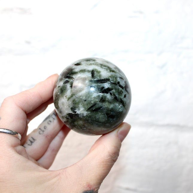 Green Tourmaline in Quartz Sphere - 57mm Stone Sphere with Plastic Display Stand Included - Green, White, and Black Stone Ball