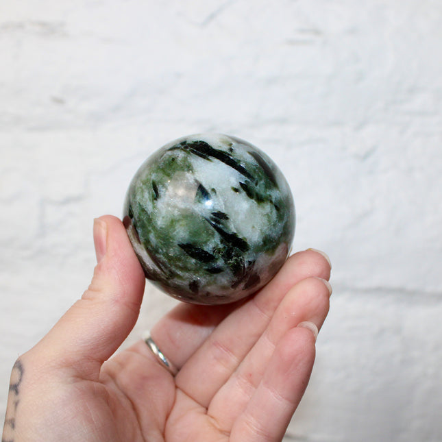 Green Tourmaline in Quartz Sphere - 57mm Stone Sphere with Plastic Display Stand Included - Green, White, and Black Stone Ball