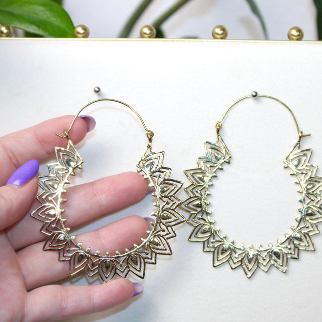 Elevate your stretched ear style with these stunning handmade gold brass ear weights, inspired by traditional Indian tribal mandala art. Crafted with care, each piece showcases intricate mandala detailing that adds a bold, spiritual elegance to any look.