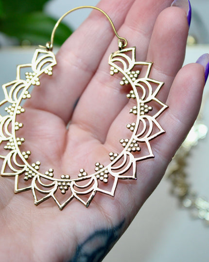 Elevate your stretched ear style with these stunning handmade gold brass ear weights, inspired by traditional Indian tribal mandala art. Crafted with care, each piece showcases intricate mandala detailing that adds a bold, spiritual elegance to any look.