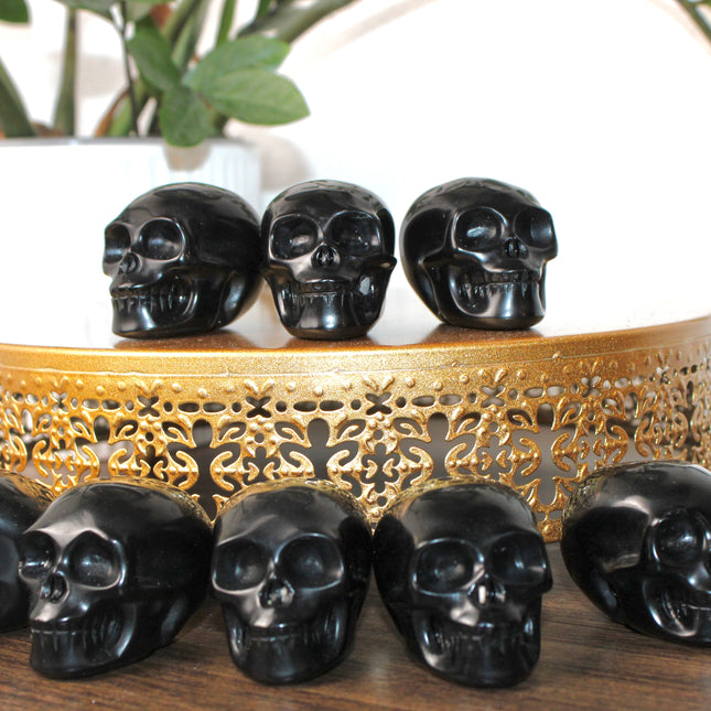 This Black Obsidian Skull Carving blends bold visual impact with detailed craftsmanship. Perfect for display in any setting, each polished obsidian skull showcases the rich depth and shine of natural volcanic glass.