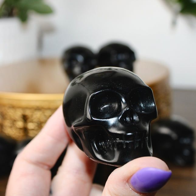 This Black Obsidian Skull Carving blends bold visual impact with detailed craftsmanship. Perfect for display in any setting, each polished obsidian skull showcases the rich depth and shine of natural volcanic glass.