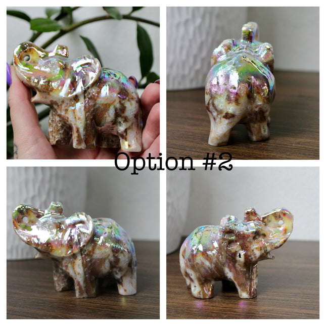 This Aura Quartz Elephant Carving features a charming hand-carved design enhanced with a brilliant rainbow electroplated finish. Made from natural quartz and treated to produce a luminous, color-shifting surface, this figurine blends natural beauty with a playful, eye-catching twist.