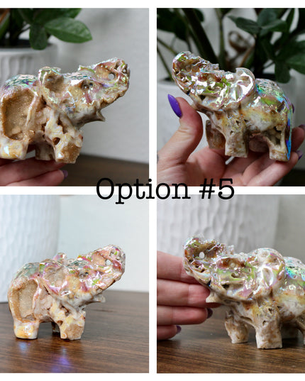 This Aura Quartz Elephant Carving features a charming hand-carved design enhanced with a brilliant rainbow electroplated finish. Made from natural quartz and treated to produce a luminous, color-shifting surface, this figurine blends natural beauty with a playful, eye-catching twist.