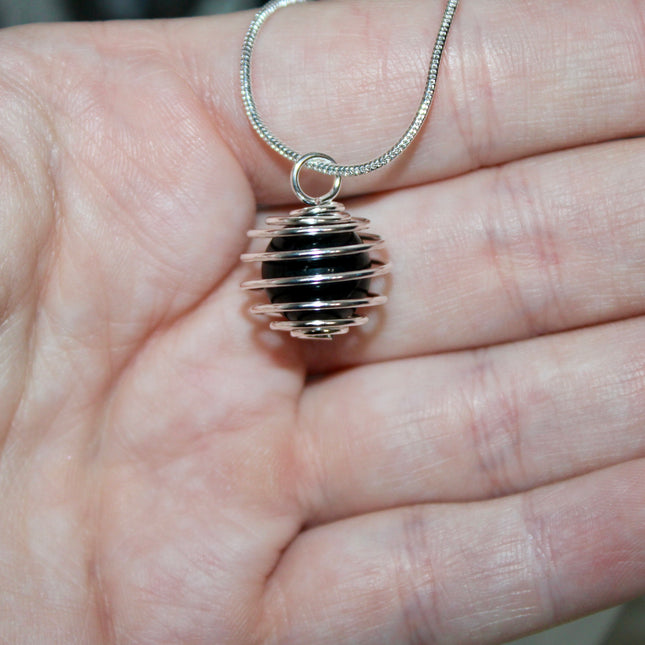 This Spiral Cage Crystal Sphere Necklace offers both beauty and function—allowing you to change out crystal spheres based on your energy or intention for the day. Whether you're seeking clarity, protection, calm, or empowerment, there’s a stone to support your journey.