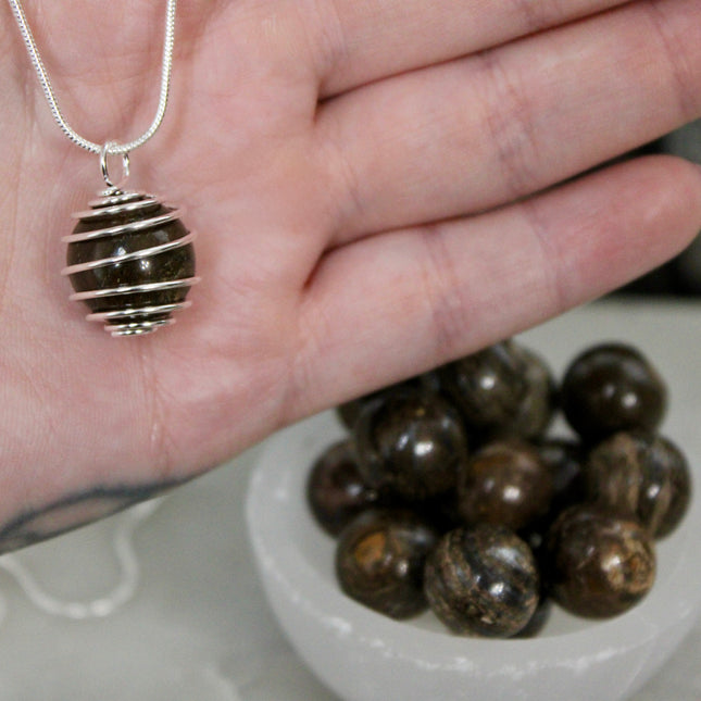 This Spiral Cage Crystal Sphere Necklace offers both beauty and function—allowing you to change out crystal spheres based on your energy or intention for the day. Whether you're seeking clarity, protection, calm, or empowerment, there’s a stone to support your journey.