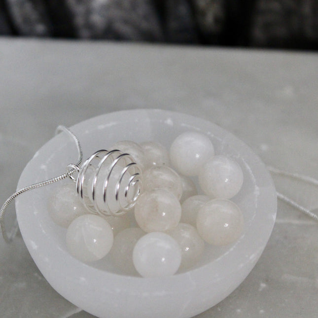 This Spiral Cage Crystal Sphere Necklace offers both beauty and function—allowing you to change out crystal spheres based on your energy or intention for the day. Whether you're seeking clarity, protection, calm, or empowerment, there’s a stone to support your journey.