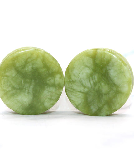 These double flare plugs are crafted from authentic South Jade, a naturally green stone known for its smooth texture and subtle color variations. Hand-polished for a glossy finish, each plug is shaped for comfortable daily wear while showcasing the calming, earthy tones of the stone.