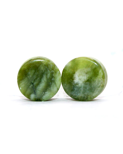These double flare plugs are crafted from authentic South Jade, a naturally green stone known for its smooth texture and subtle color variations. Hand-polished for a glossy finish, each plug is shaped for comfortable daily wear while showcasing the calming, earthy tones of the stone.