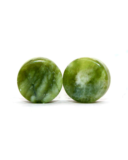 These double flare plugs are crafted from authentic South Jade, a naturally green stone known for its smooth texture and subtle color variations. Hand-polished for a glossy finish, each plug is shaped for comfortable daily wear while showcasing the calming, earthy tones of the stone.