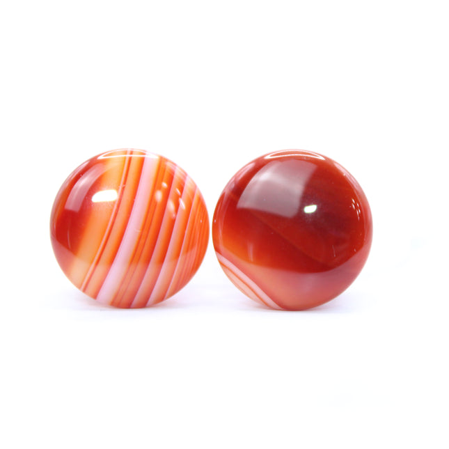 These single flare plugs are carved from genuine Carnelian Agate, showcasing warm, fiery hues and occasional natural banding or translucent zones. Hand-polished to a sleek finish, each plug is smooth and comfortable for everyday wear.