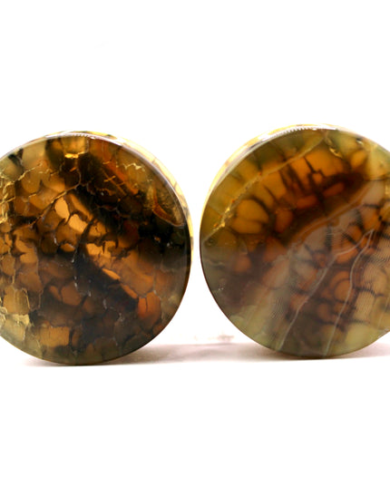 These Yellow and Black Dragon Vein Agate Plugs offer a striking blend of color and texture, featuring polished surfaces and natural-looking crackle patterns. Designed in a secure double flare style, they’re a bold and stylish option for stretched ears.