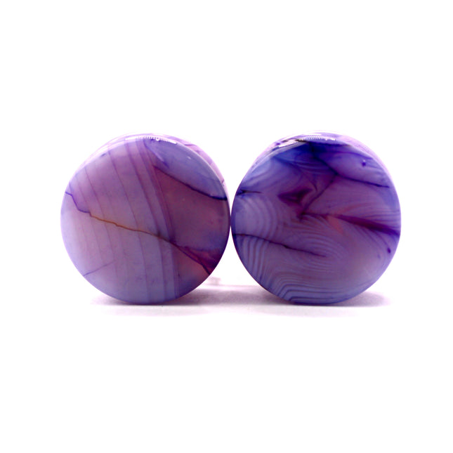 These Purple Striped Agate Plugs showcase eye-catching banded patterns and vivid color in a comfortable double flare design. Polished to a glossy finish, they’re a stylish choice for stretched ear jewelry collections.
