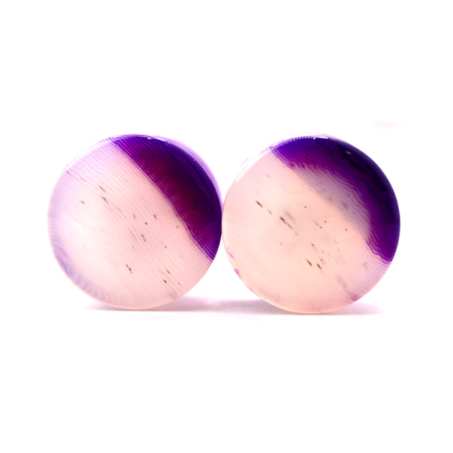 These Purple Striped Agate Plugs showcase eye-catching banded patterns and vivid color in a comfortable double flare design. Polished to a glossy finish, they’re a stylish choice for stretched ear jewelry collections.