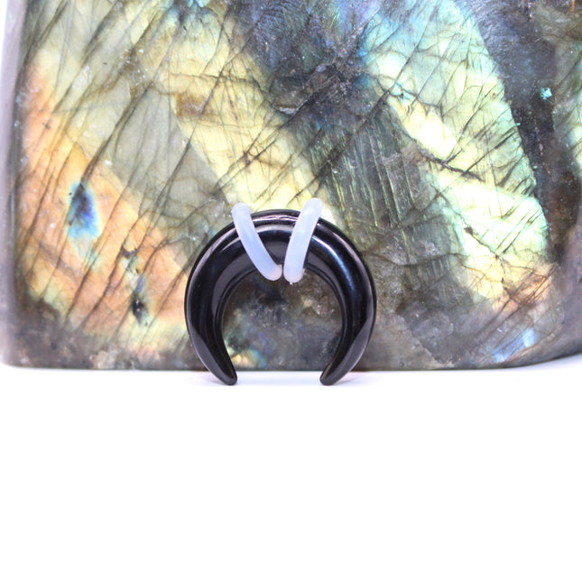 This Obsidian Septum Pincher is carved from genuine volcanic glass and polished to a smooth, glossy finish.