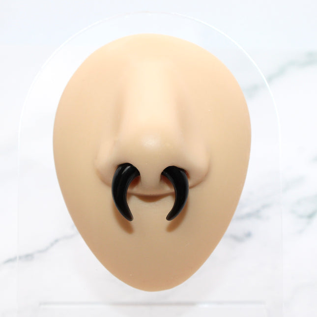 This Obsidian Septum Pincher is carved from genuine volcanic glass and polished to a smooth, glossy finish.