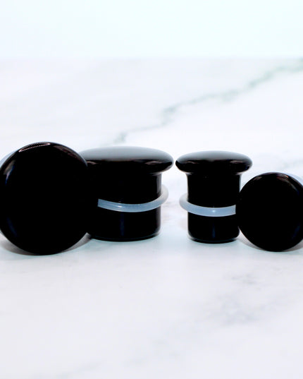 These Black Obsidian Single Flare Plugs are carved from genuine volcanic glass and polished for a bold, minimalist look. The secure single flare design with O-rings ensures comfortable, everyday wear for stretched lobes.