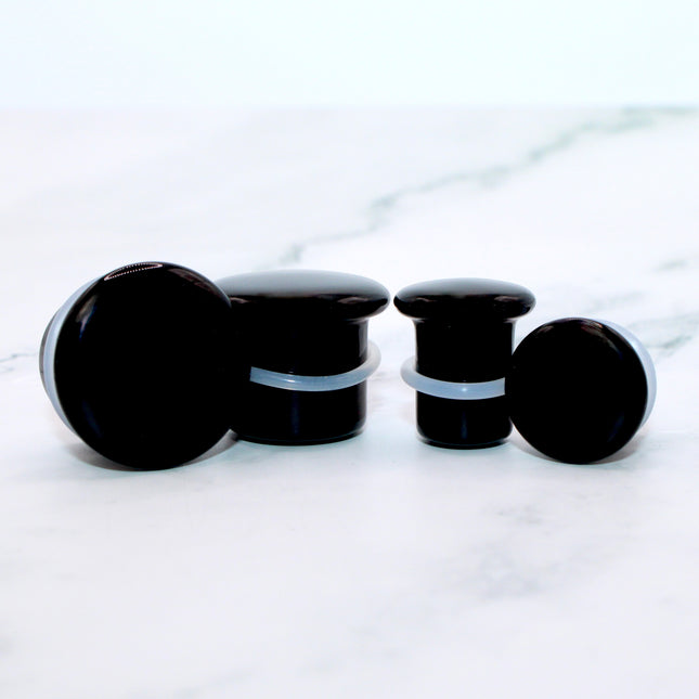 These Black Obsidian Single Flare Plugs are carved from genuine volcanic glass and polished for a bold, minimalist look. The secure single flare design with O-rings ensures comfortable, everyday wear for stretched lobes.