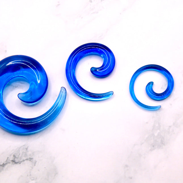 These Blue Acrylic Spiral Tapers offer a bold, colorful twist to your stretched ear collection. With their vibrant blue tone and swirling design, they’re perfect for adding movement and personality to your look. Made from lightweight acrylic, they’re easy to wear and ideal for daily use or special occasions.