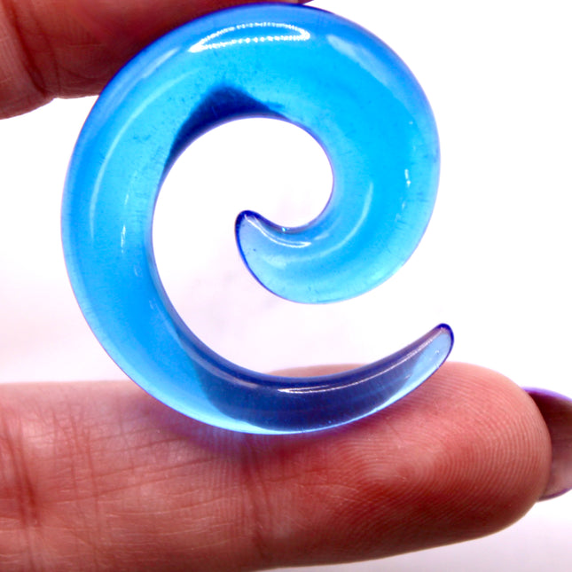 These Blue Acrylic Spiral Tapers offer a bold, colorful twist to your stretched ear collection. With their vibrant blue tone and swirling design, they’re perfect for adding movement and personality to your look. Made from lightweight acrylic, they’re easy to wear and ideal for daily use or special occasions.