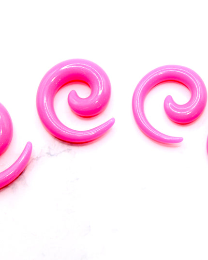 These Pink Acrylic Spiral Taper Earrings are a stylish and low-maintenance option for stretched ears. The sleek spiral design adds visual interest while remaining lightweight and easy to wear. Perfect for everyday use or to enhance your alt aesthetic, these tapers offer a bold yet classic look.