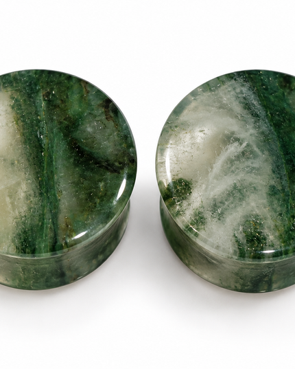 Two round green stone plugs with natural marbled patterns, displayed side-by-side on a white background.