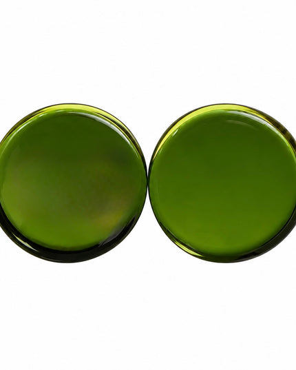 Two oval green gauges gemstones shown side-by-side on a plain white background.
