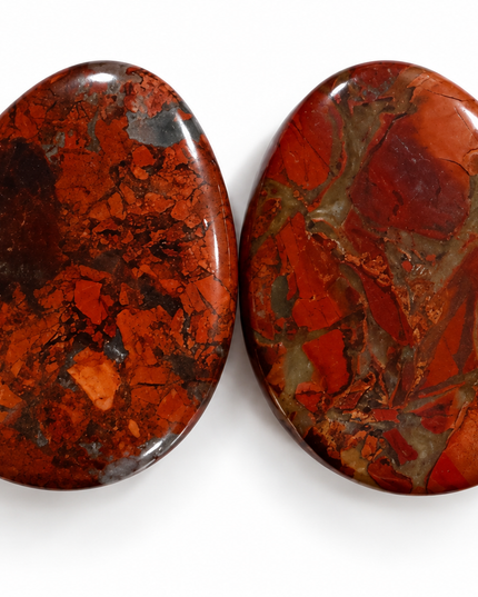 Two polished teardrop-shaped gemstone cabochons with rich red, orange, and brown jasper patterns, displayed side-by-side on a clean white background.