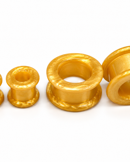Four gold-colored textured tunnel of varying sizes arranged on a plain white background.