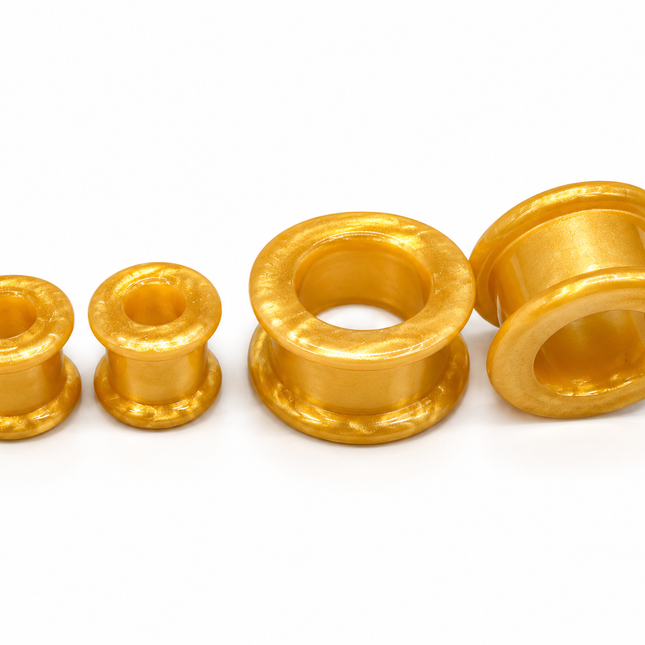Four gold-colored textured tunnel of varying sizes arranged on a plain white background.