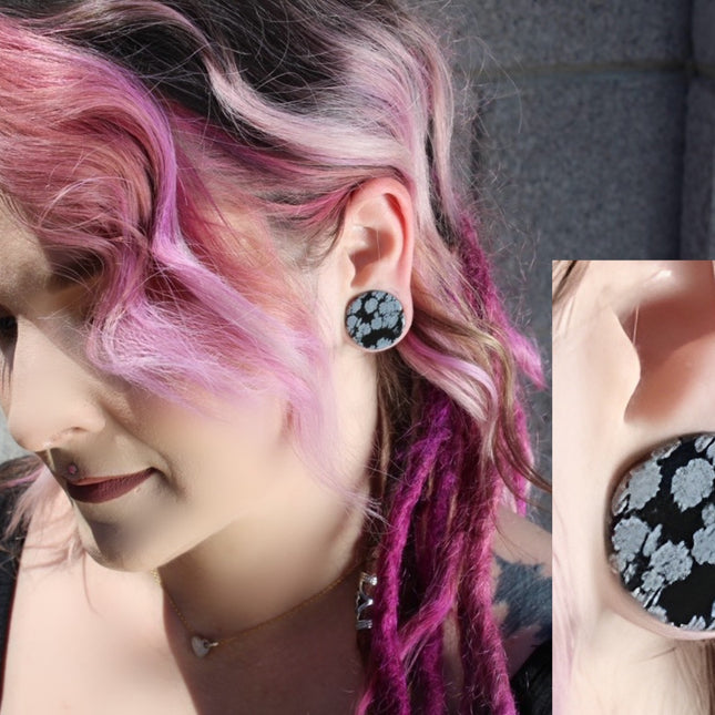 These Snowflake Obsidian Double Flared Plugs feature a smooth, polished surface with natural gray-white crystal "snowflakes" scattered across a rich black volcanic glass base. The double flare ensures a secure, comfortable fit for stretched ears without the need for O-rings. Each pair is uniquely patterned, showcasing the stone’s natural beauty and grounding energy. Durable and stylish, these plugs add a bold yet refined touch to any stretched ear jewelry collection.