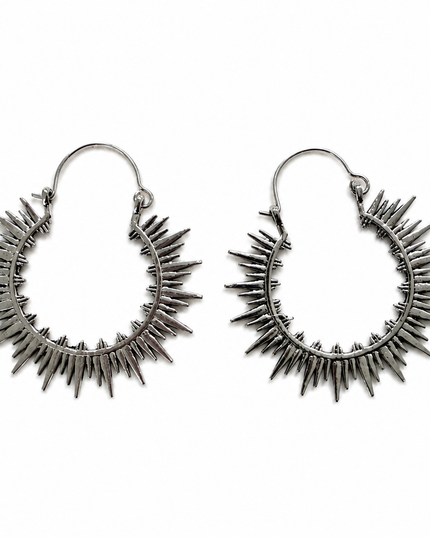 A pair of silver-toned hoop earrings with a spiky sunburst design, displayed on a clean white background.