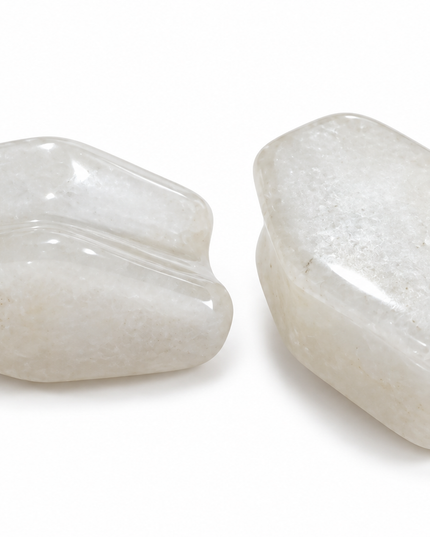 Two polished white gauge stone with smooth curved surfaces, displayed side by side on a clean white background.
