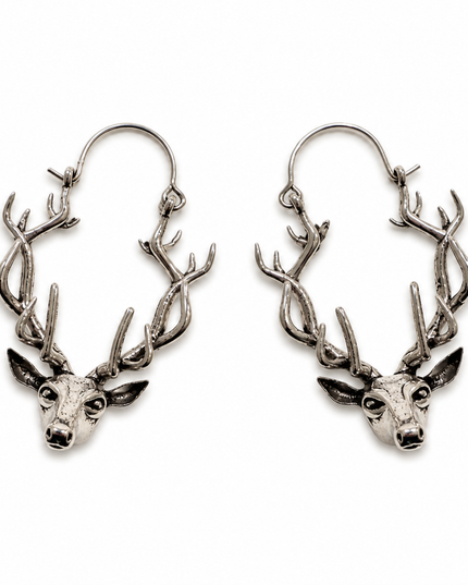 A pair of silver-toned hoop earrings featuring a detailed stag head and antlers at the center of each hoop, shown against a plain white background.